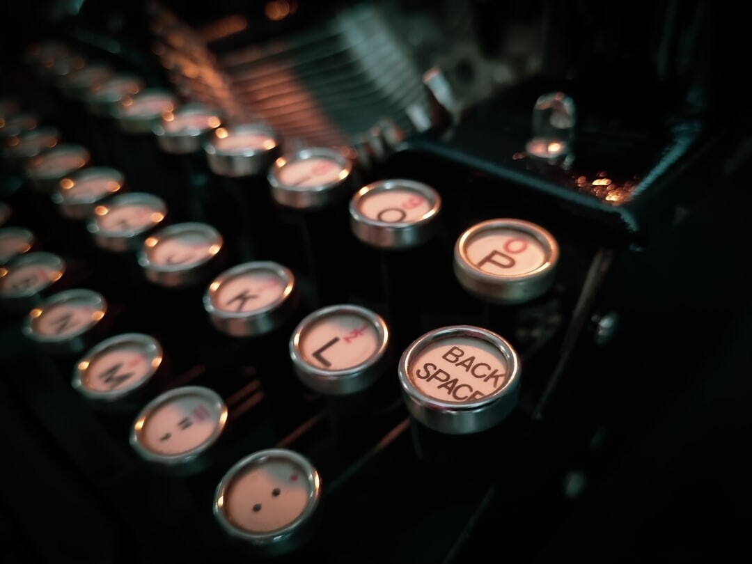 Close up of vintage typewriter keys with a sheet of paper