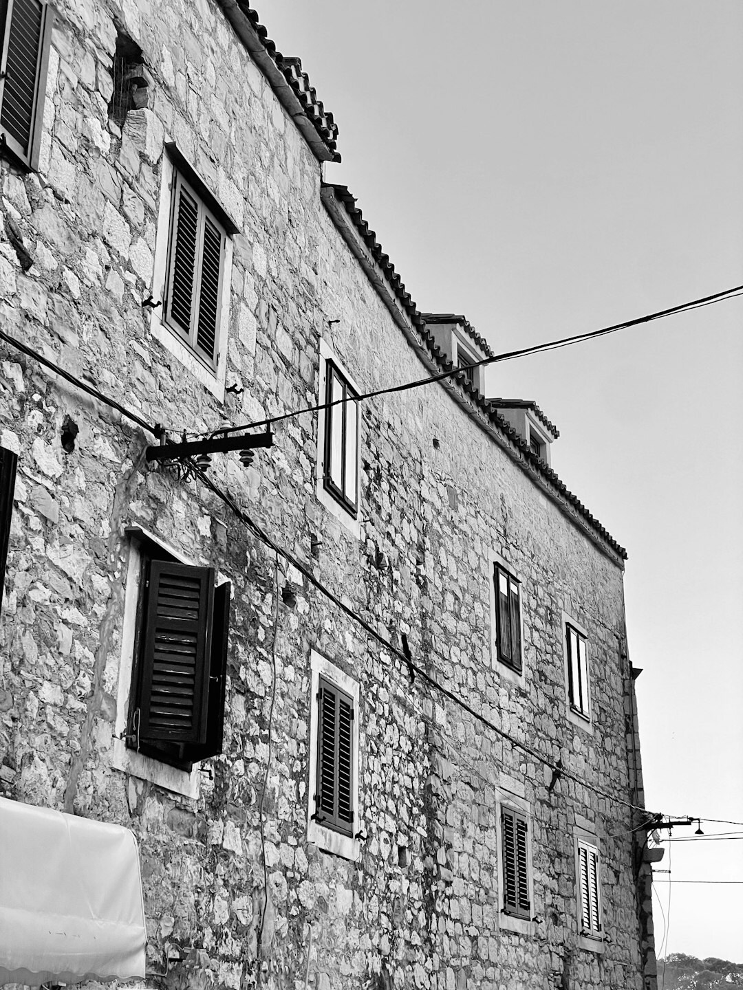 Old stone house on the Croatian coast wrapped in evening fog