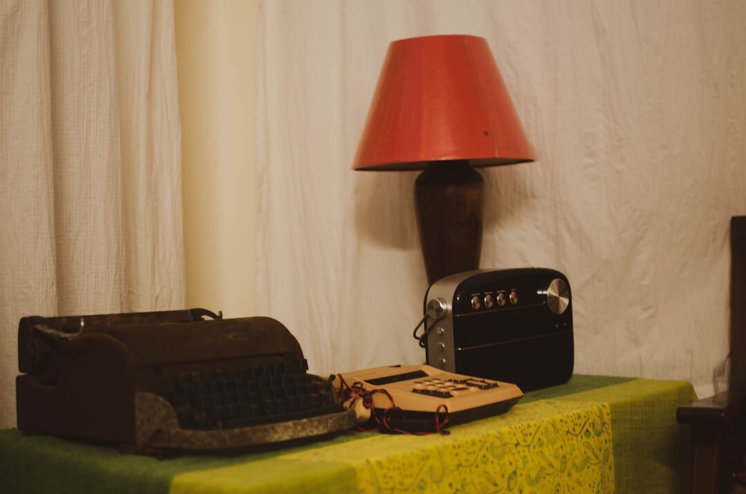 Vintage wooden writing desk with typewriter and warm lamp light